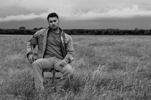 man sitting in field