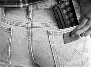 Person wearing jeans with a wallet in the back pocket